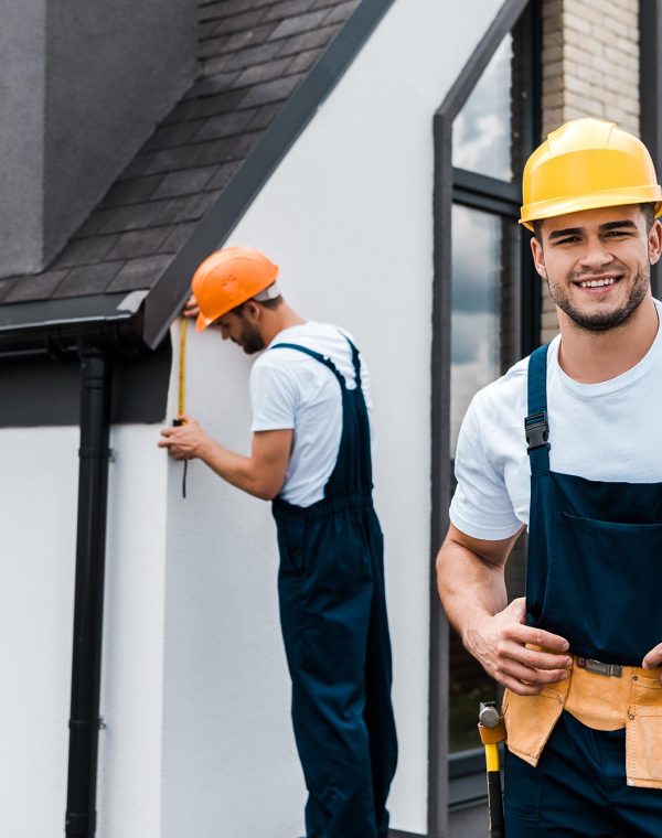 selective-focus-of-happy-handyman-in-uniform-near-service.jpg